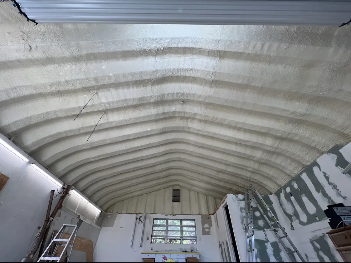Spray polyurethane foam applied to the underside of a metal roof deck in Granbury